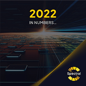 First slide of the impact report. A decorative image of solar panels with a setting sun above it. Over the image, the words "2022 in numbers..." are shown. Spectral's logo is at the bottom right of the page.